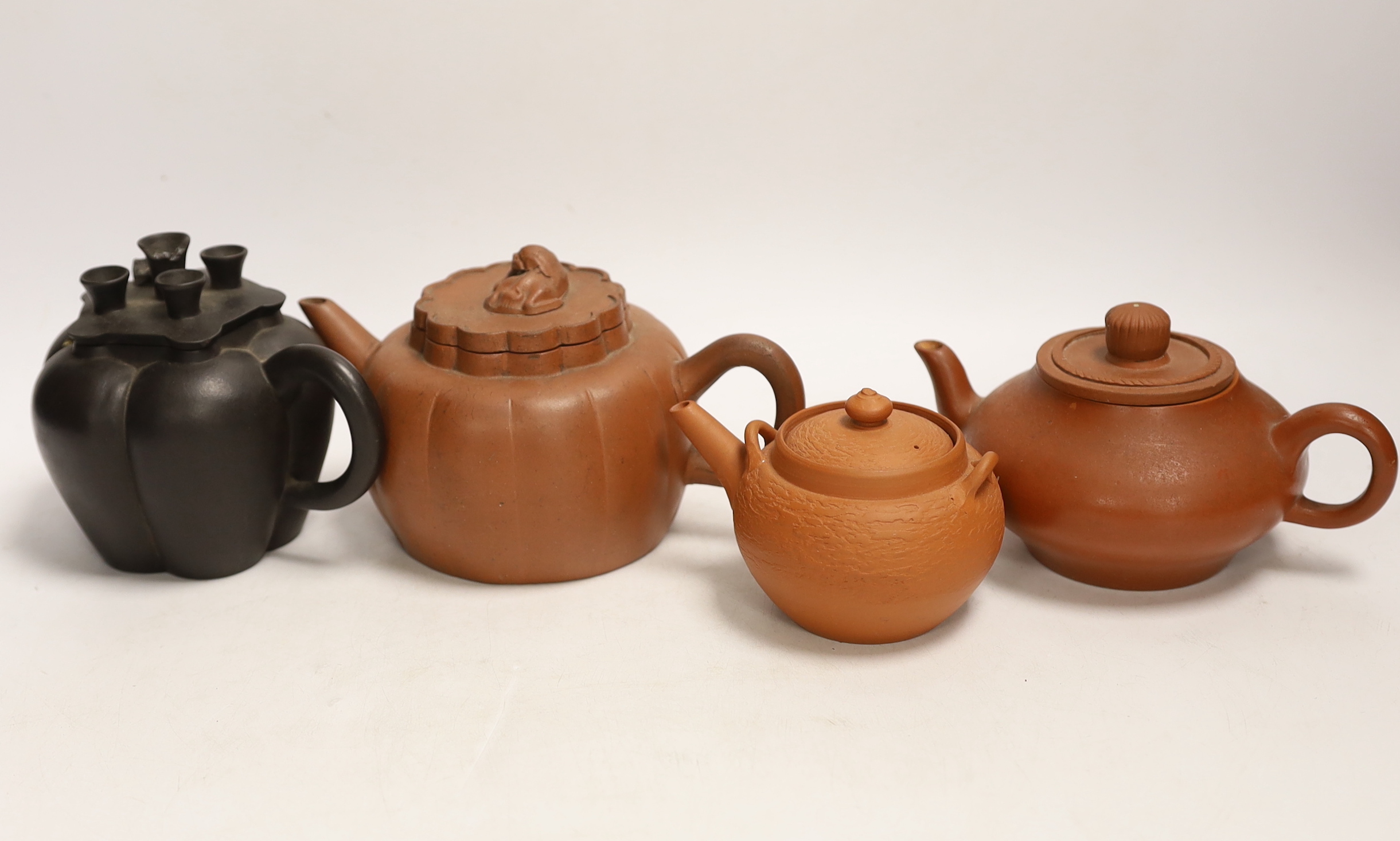 Four Chinese Yixing terracotta teapots, largest 10cm